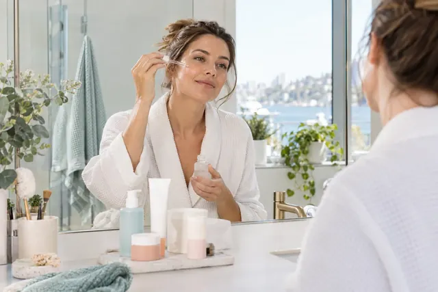 Illustrative skincare routine at a bathroom mirror.